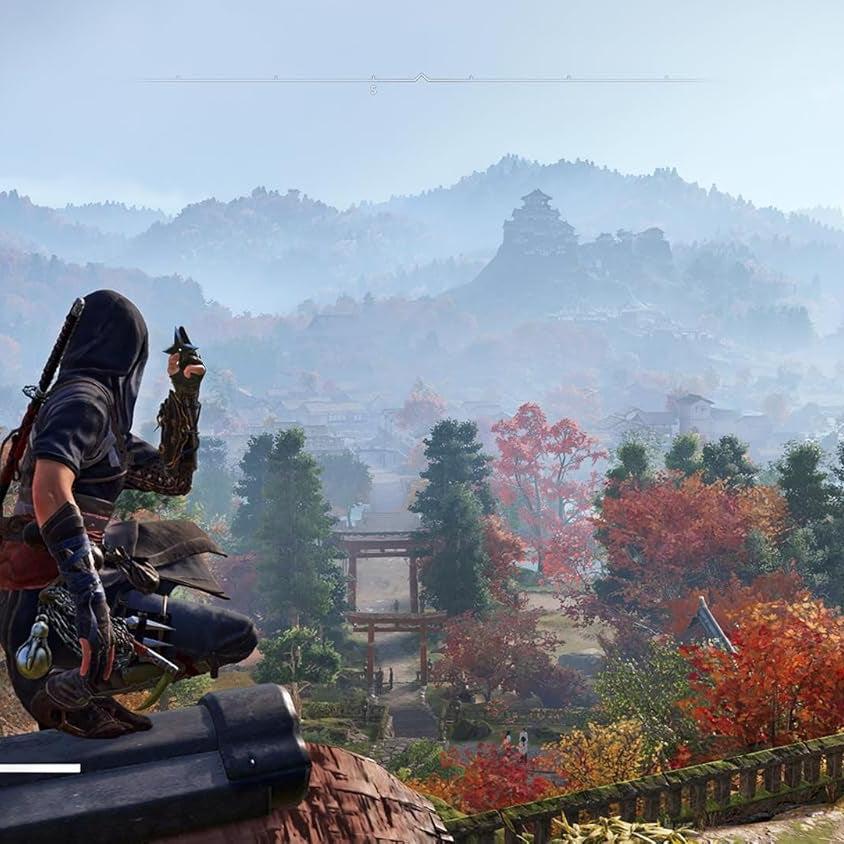 Assassin's Creed Shadows gameplay showing a hooded shinobi on a rooftop overlooking a vibrant feudal Japan landscape with mountains and a castle.